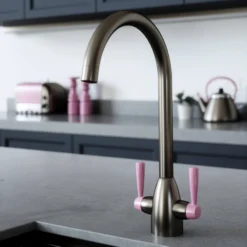 The Tap Factory Vibrance 2 Gunmetal Twin Lever Mono Kitchen Mixer With Post Box Red Handles -Vado Shop tap factory vibrance 2 gunmetal with pink handle lifestyle
